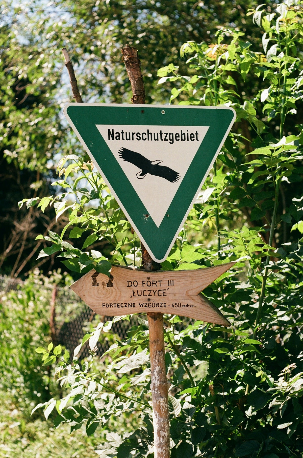 German nature reserve sign and wooden directional arrow.